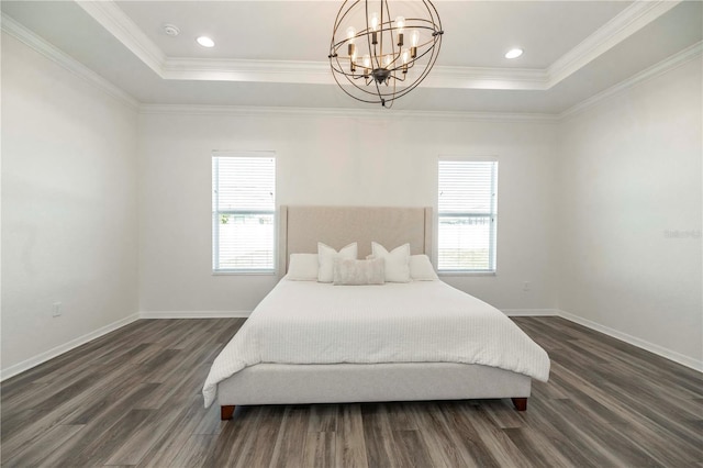 bedroom with multiple windows, a tray ceiling, and dark wood-type flooring