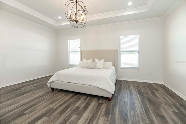 bedroom with a tray ceiling, dark hardwood / wood-style flooring, and multiple windows