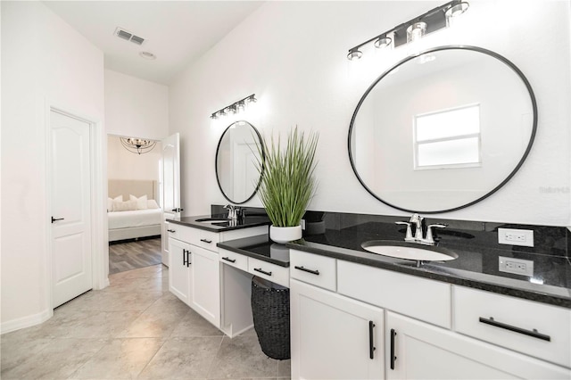 bathroom featuring tile patterned flooring and vanity