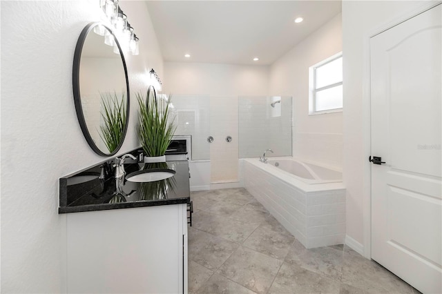 bathroom with vanity and independent shower and bath