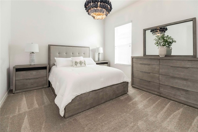 carpeted bedroom featuring a chandelier