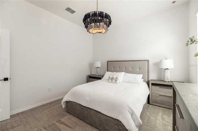 carpeted bedroom featuring a notable chandelier