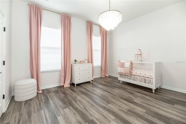 bedroom featuring dark hardwood / wood-style flooring, a chandelier, and multiple windows