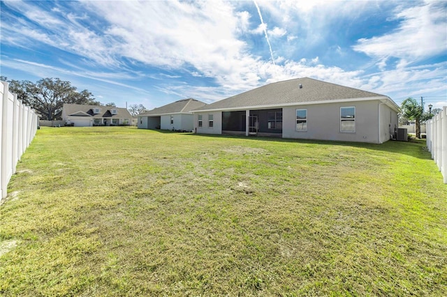 back of property featuring cooling unit and a lawn