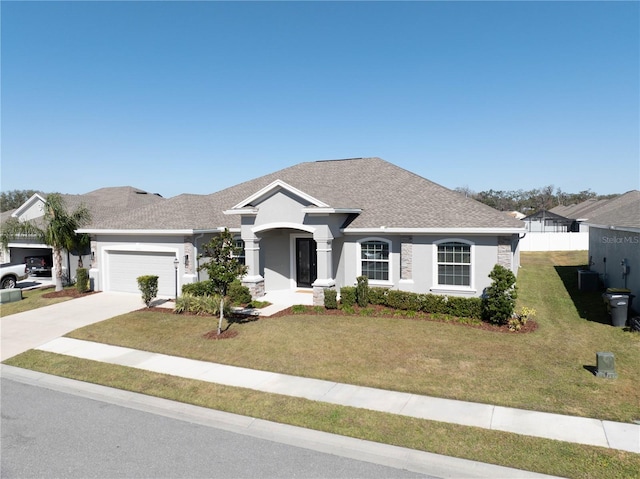 ranch-style home featuring a garage and a front yard