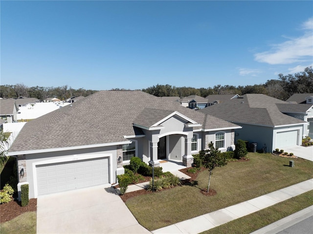 view of front facade featuring a garage and a front lawn