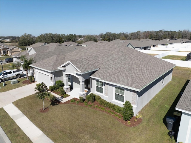 view of front of home featuring a garage and a front yard