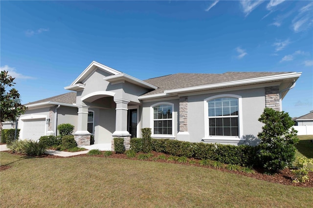 view of front of property with a garage and a front yard