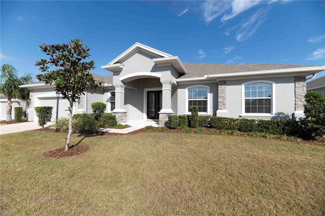 view of front of home with a garage and a front lawn