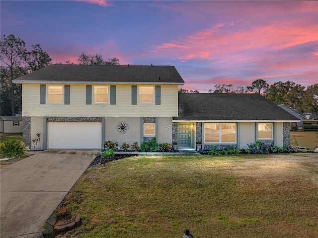 view of front of house with a yard and a garage