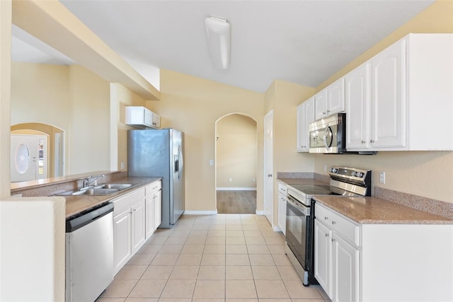 kitchen with white cabinetry, sink, light tile patterned floors, and stainless steel appliances