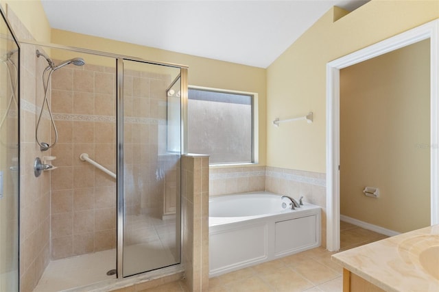 bathroom with tile patterned flooring, vanity, and separate shower and tub