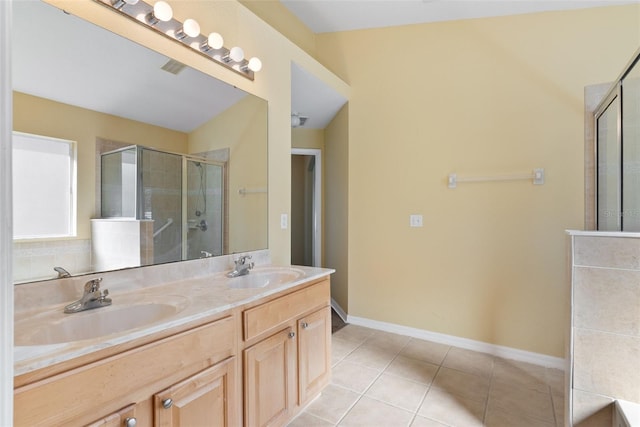 bathroom featuring vanity, tile patterned floors, and walk in shower