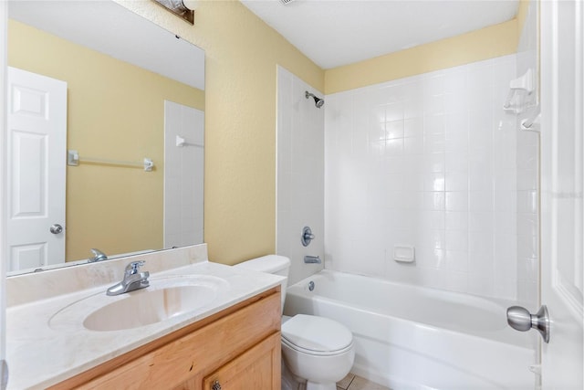 full bathroom with tiled shower / bath, vanity, and toilet