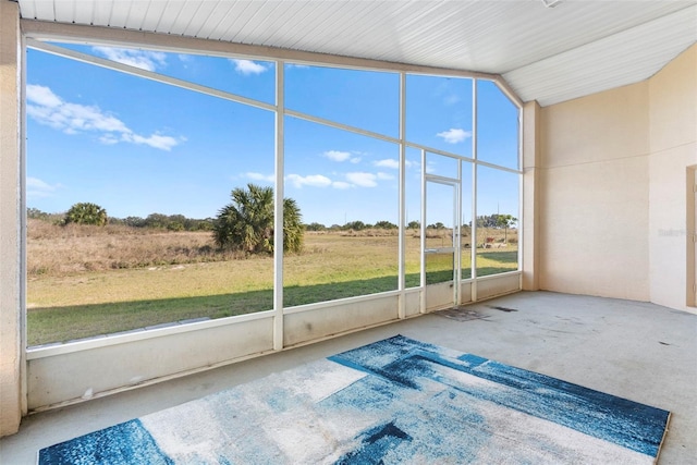 unfurnished sunroom featuring a rural view