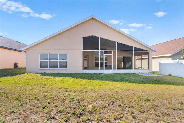 back of house featuring a sunroom and a yard