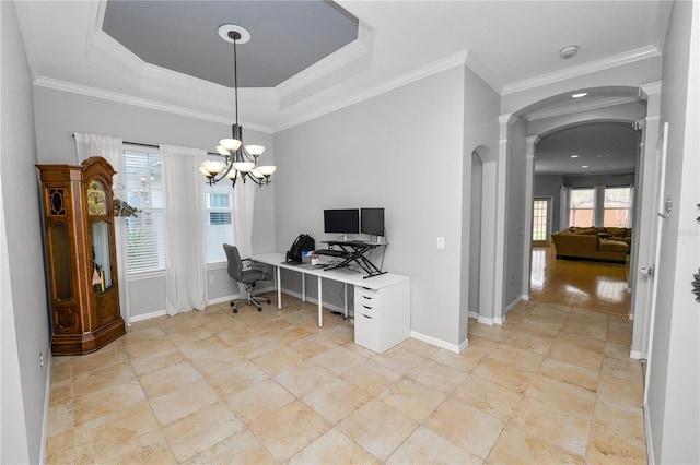 office space with crown molding, plenty of natural light, and a raised ceiling