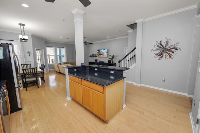 kitchen featuring ornamental molding, stainless steel refrigerator, ceiling fan, and light wood-type flooring