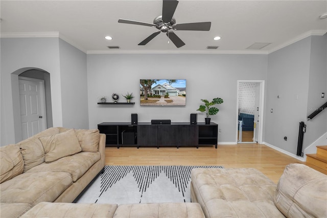 living room featuring crown molding, ceiling fan, and hardwood / wood-style floors