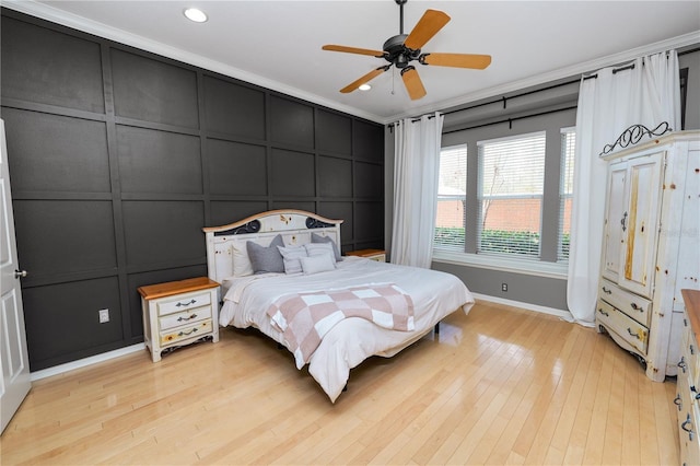 bedroom featuring crown molding, light hardwood / wood-style flooring, and ceiling fan