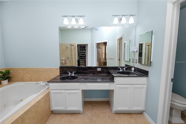 full bathroom featuring vanity, tile patterned flooring, toilet, and separate shower and tub