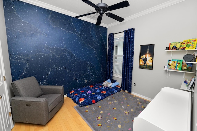 bedroom featuring crown molding, wood-type flooring, and ceiling fan