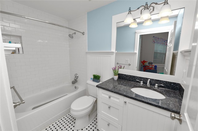 full bathroom with vanity, tiled shower / bath combo, and toilet