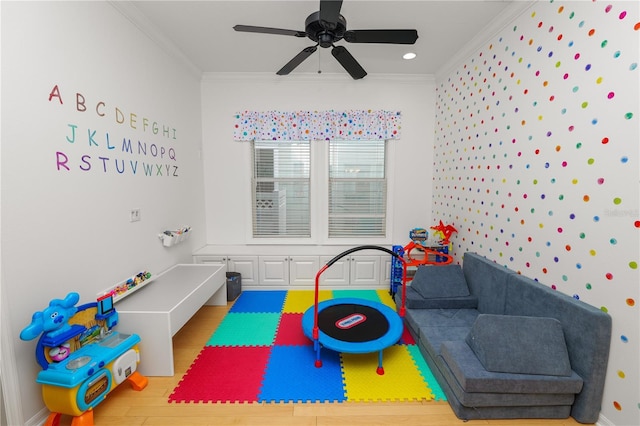 game room featuring ornamental molding, wood-type flooring, and ceiling fan