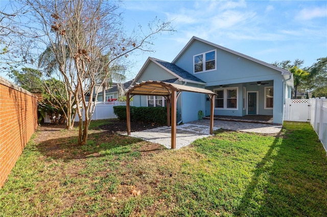 back of property featuring a patio, a yard, ceiling fan, and a pergola