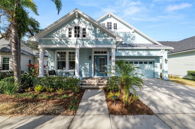 view of front of house featuring a garage and a porch