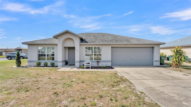 ranch-style house with a garage and a front lawn