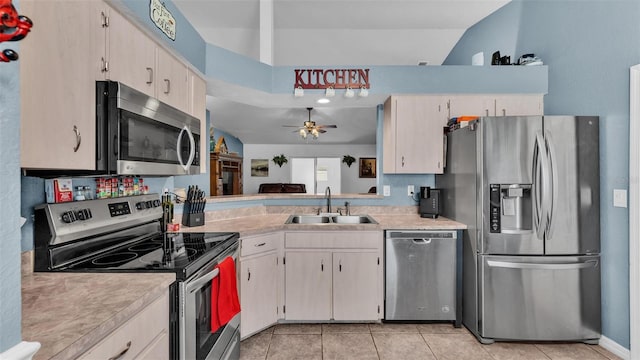 kitchen with light tile patterned flooring, ceiling fan, stainless steel appliances, and sink