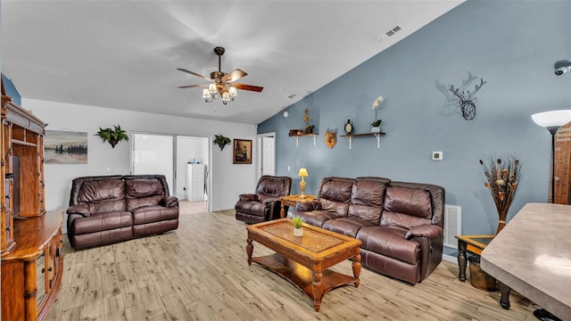 living room with vaulted ceiling, ceiling fan, and light wood-type flooring