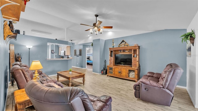 living room featuring ceiling fan, lofted ceiling, and light wood-type flooring