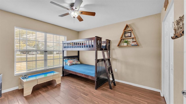 bedroom with hardwood / wood-style floors and ceiling fan