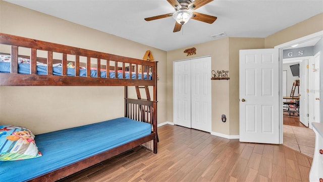 bedroom featuring hardwood / wood-style floors, a closet, and ceiling fan