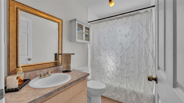 bathroom with tile patterned floors, vanity, and toilet