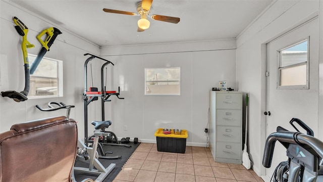 workout area with light tile patterned flooring, ceiling fan, and crown molding