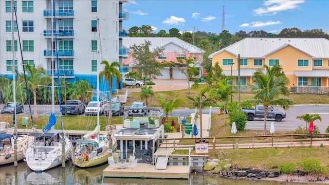 exterior space with a water view and a boat dock