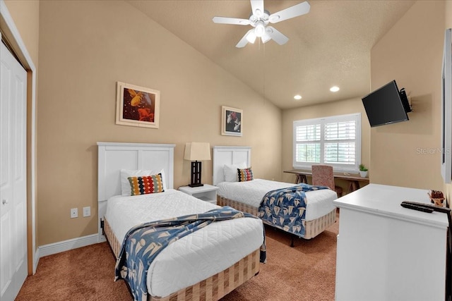 carpeted bedroom with ceiling fan, vaulted ceiling, and a closet