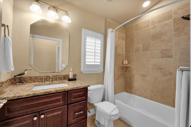 full bathroom with shower / tub combo with curtain, vanity, and toilet