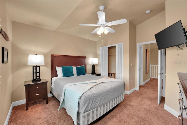 bedroom featuring light carpet, vaulted ceiling, and a closet