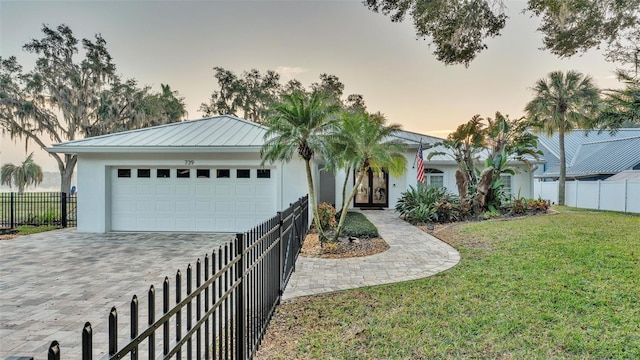 view of front facade with a garage and a yard