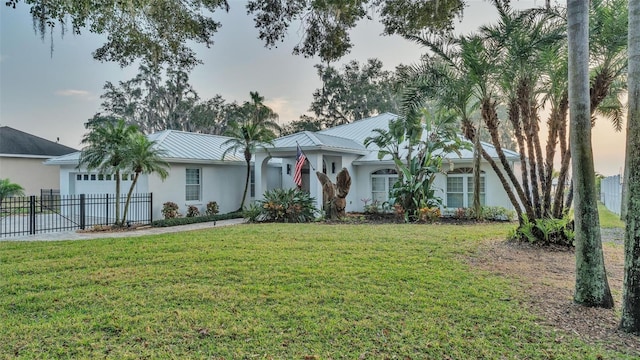 ranch-style home featuring a yard and a garage