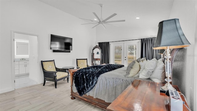 bedroom featuring high vaulted ceiling, light wood-type flooring, access to exterior, ensuite bath, and french doors