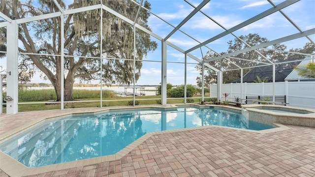 view of swimming pool featuring an in ground hot tub, a lanai, and a patio