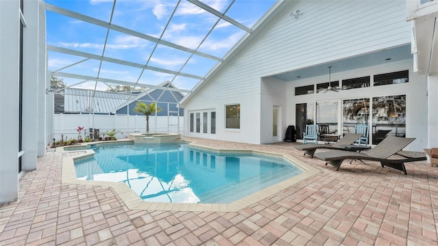 view of pool featuring an in ground hot tub, ceiling fan, a lanai, and a patio