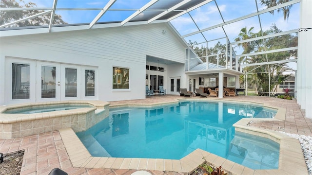 view of swimming pool featuring an in ground hot tub, a lanai, ceiling fan, an outdoor living space, and a patio area