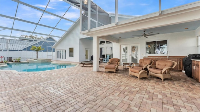 view of swimming pool featuring french doors, glass enclosure, ceiling fan, an outdoor hangout area, and a patio