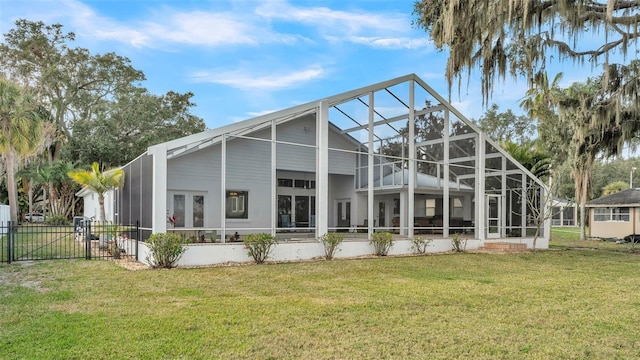 rear view of property with a yard and glass enclosure